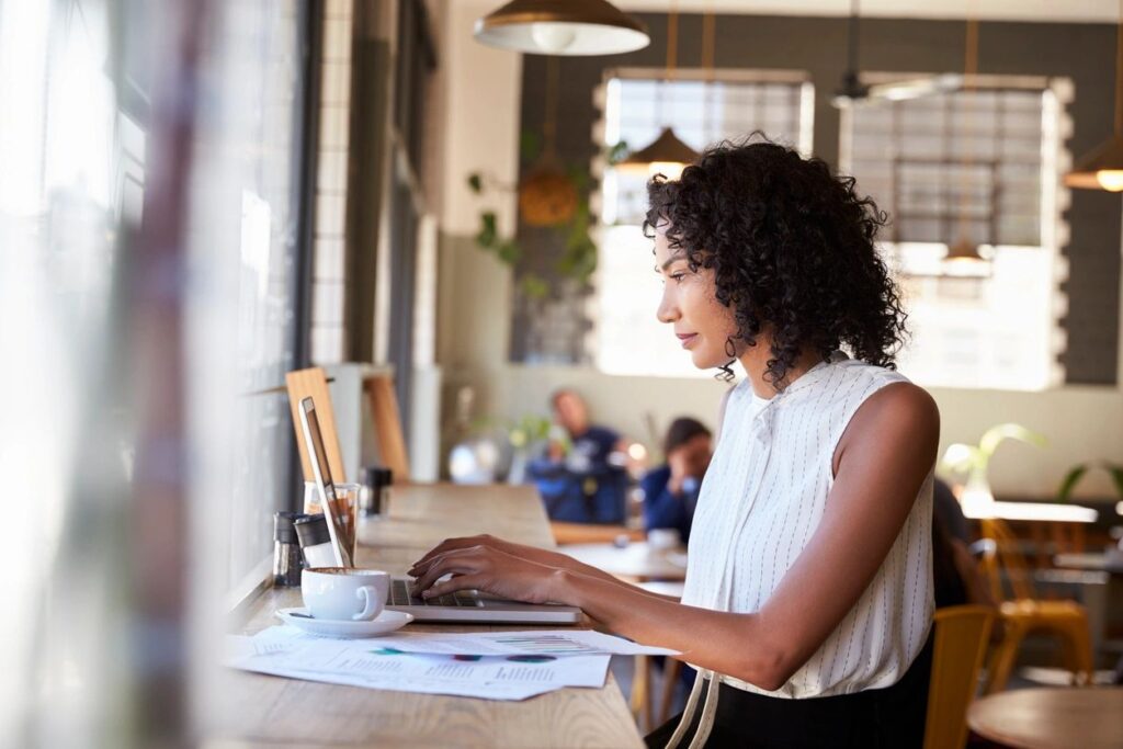 woman sitting at computer in cafe