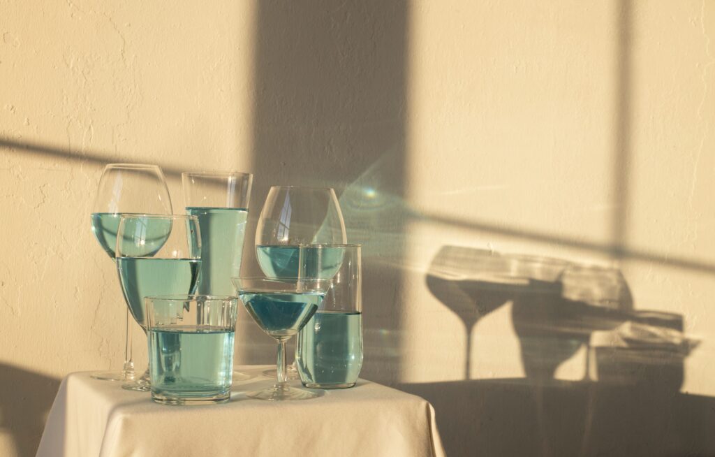 A table with glasses of wine and water on it